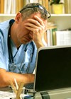 Photo of doctor looking stressed.